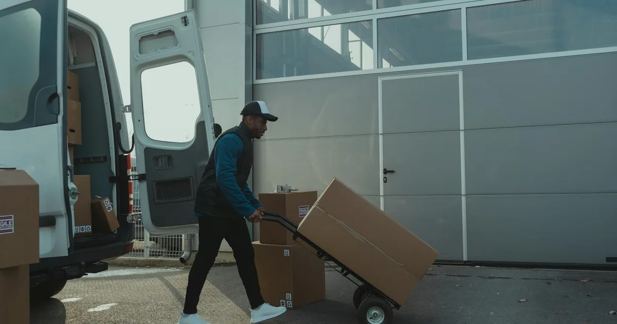 SLP Express courier driver collecting an international parcel for same-day pickup from a home in Hyderabad